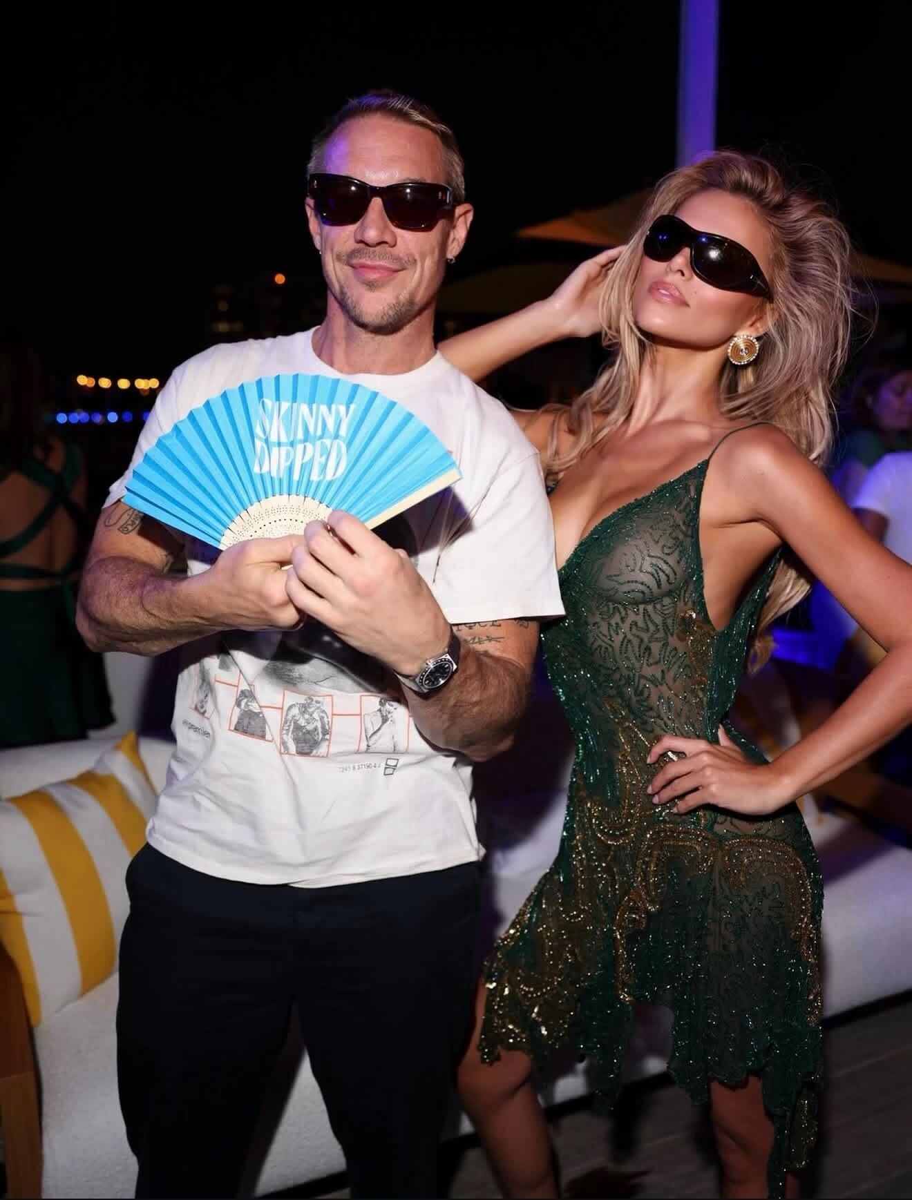 Guests with Skinny Dipped hand fans at event