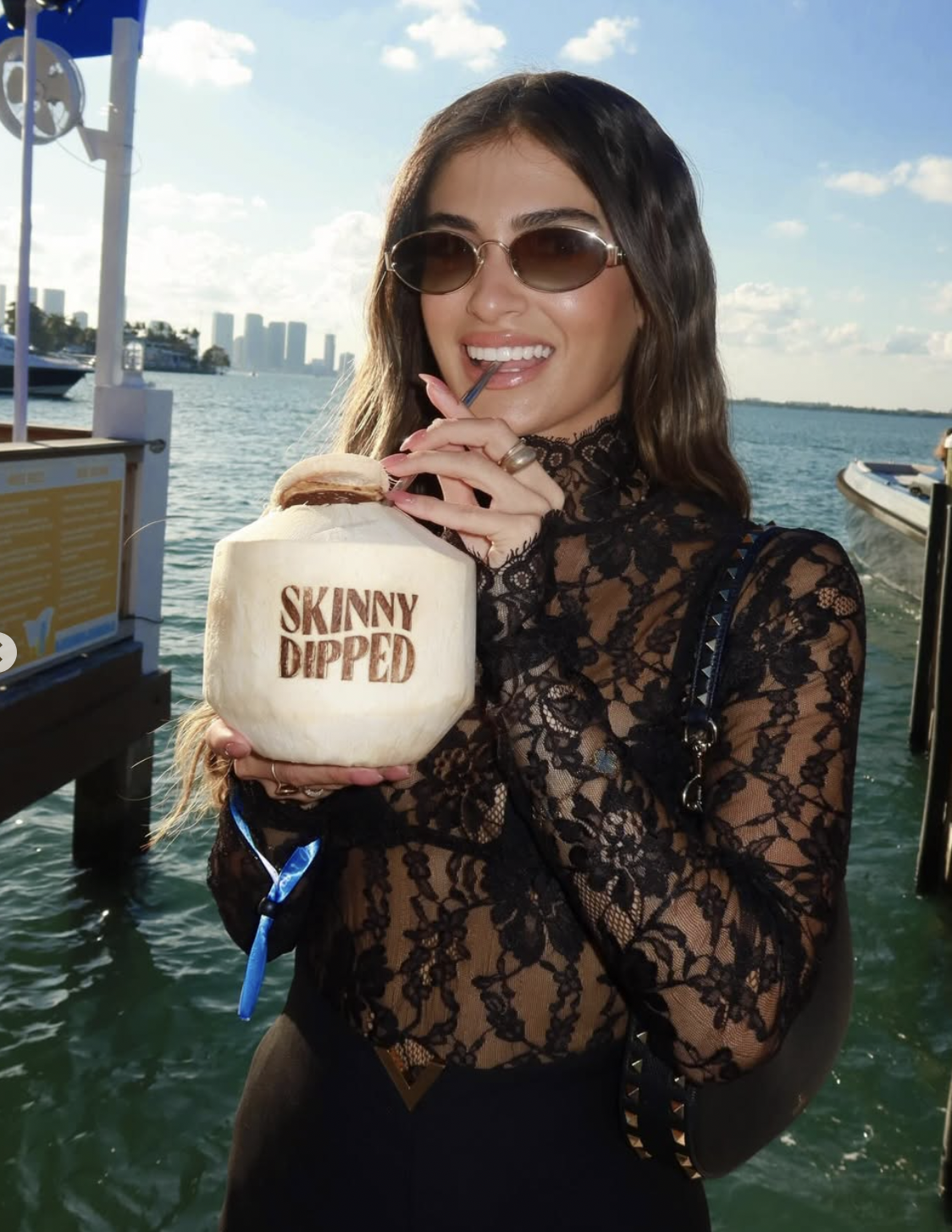 Influencer with Skinny Dipped coconut at waterfront